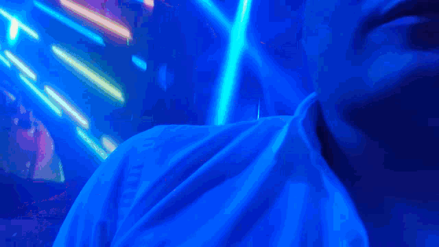a close up of a person 's face with blue lights behind it