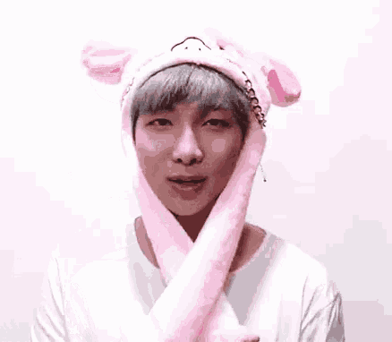 a man wearing a pink hat with bunny ears on it