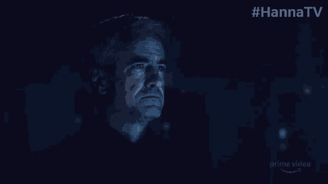 a man with gray hair is looking at something in a dark room with the hashtag #hannatv