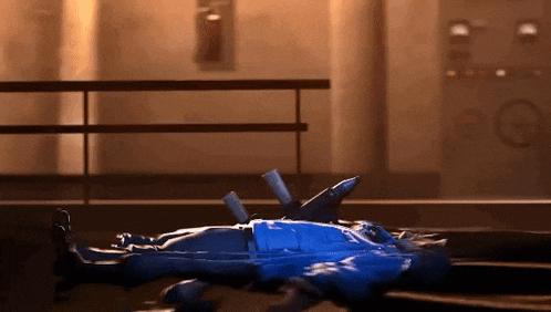 a person in a blue suit is laying on the ground