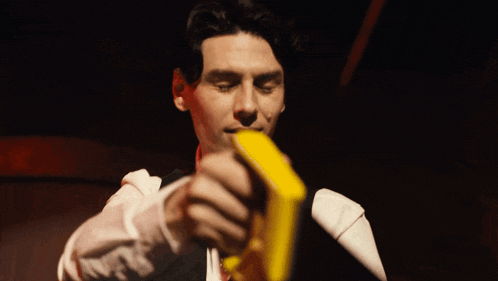 a man with blood on his face is holding a piece of paper