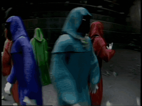 shadow wizard and money gang are holding signs in a dark room