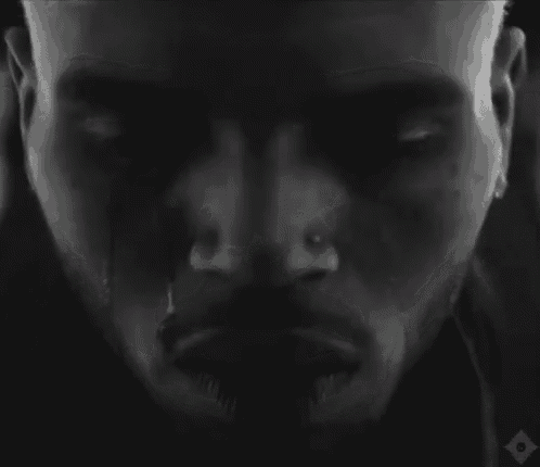 a black and white photo of a man 's face with a tear coming out of his nose .