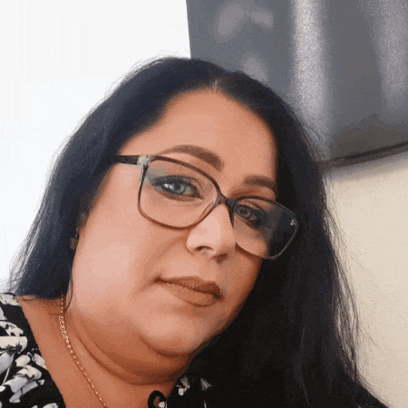 a woman wearing glasses and a floral shirt