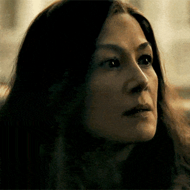 a close up of a woman 's face with a dark background