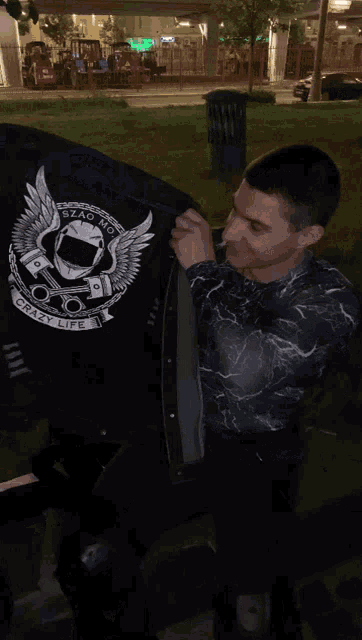a man holds up a flag that says ' stad boys ' on it