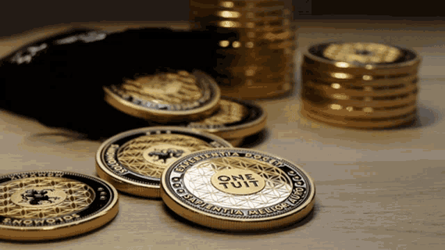 several gold coins with one that says one tuit on it