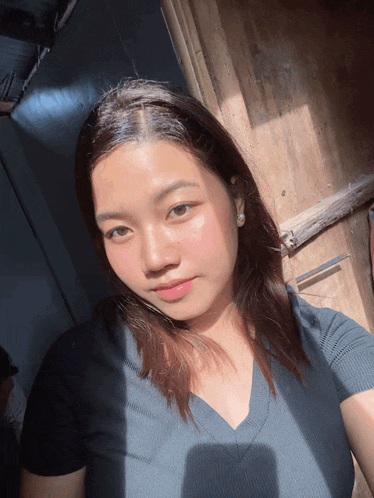 a woman taking a selfie with the sun shining through her hair