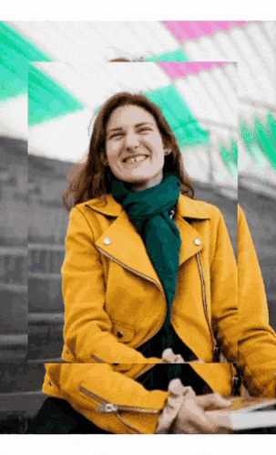 a woman wearing a yellow jacket and a green scarf smiles