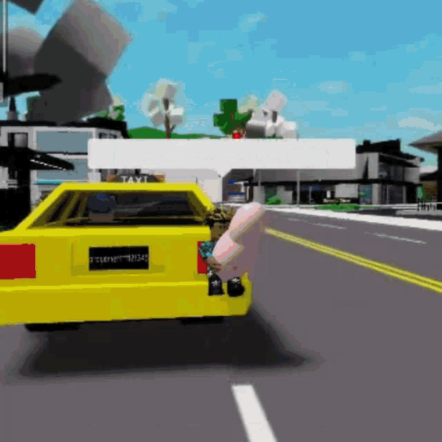 a yellow car is driving down a street with a person in the back