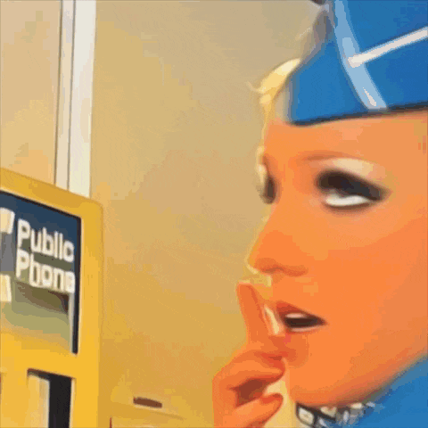 a woman in a blue hat is talking on a telephone