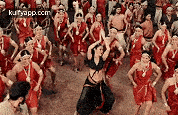 a group of people are dancing together in a crowd .