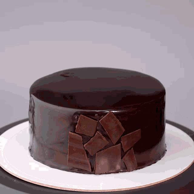 a chocolate cake with squares of chocolate on top