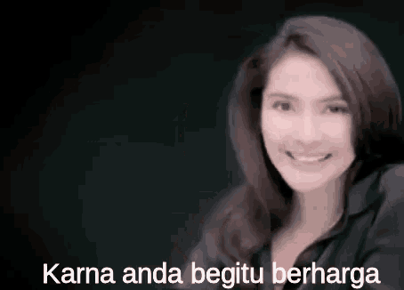 a woman is smiling in front of a black background and the words karna anda begitu berharga .