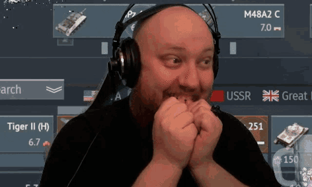 a bald man wearing headphones looks surprised in front of a screen that says ussr