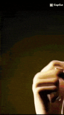 a close up of a person 's hand with a ring on it