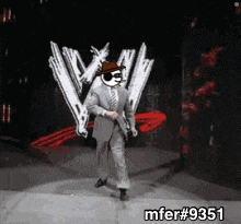 a man in a suit and tie is dancing in front of a wwe logo