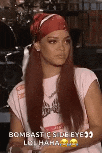 a woman wearing a red bandana and a white shirt is sitting down .