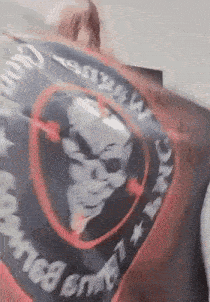 a person is holding a flag with a skull on it and the word america on it .