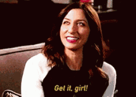 a woman is sitting on a couch and says get it girl !