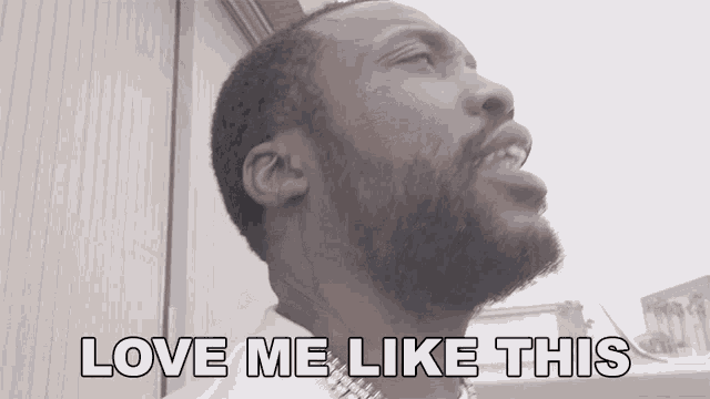 a man with a beard says " love me like this " while looking up