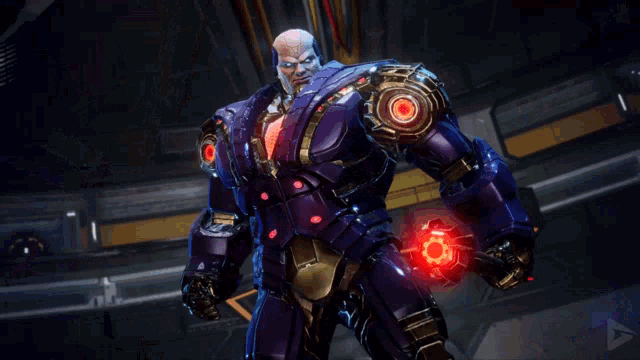 a man in a blue robot suit is standing in a dark room looking at the camera .