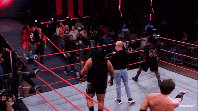 a wrestler with the number 91 on his back stands in a wrestling ring