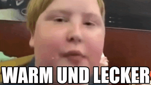 a close up of a child 's face with the words warm und lecker written above it