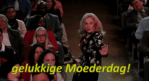 a woman is dancing in front of a crowd and the words " gelukkige moederdag " are written above her