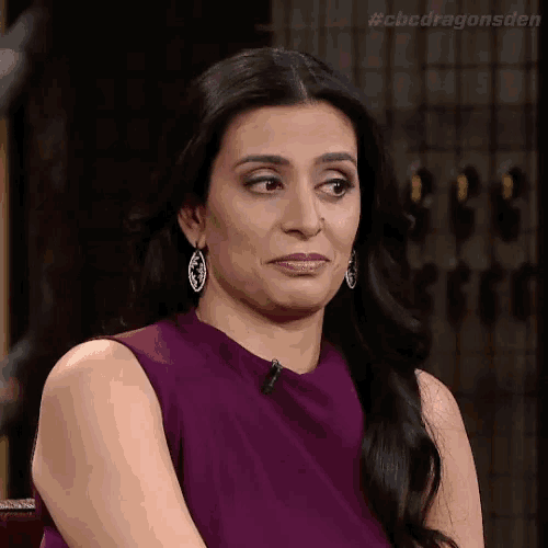 a woman in a purple dress is making a funny face