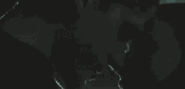 a man and a woman are kissing in the dark in a dark room .