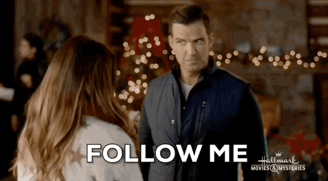 a man and a woman are standing next to each other with the words follow me written on the bottom