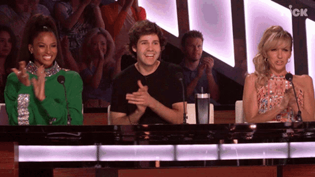 a group of people sitting at a table in front of microphones with the letters ck in the corner