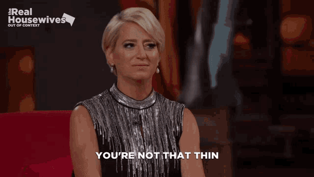 a woman says you 're not that thin in front of a sign that says real housewives