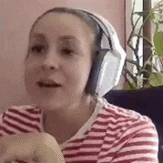 a woman wearing headphones and a striped shirt is sitting in a chair .
