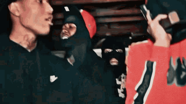 a group of men wearing ski masks are standing next to each other