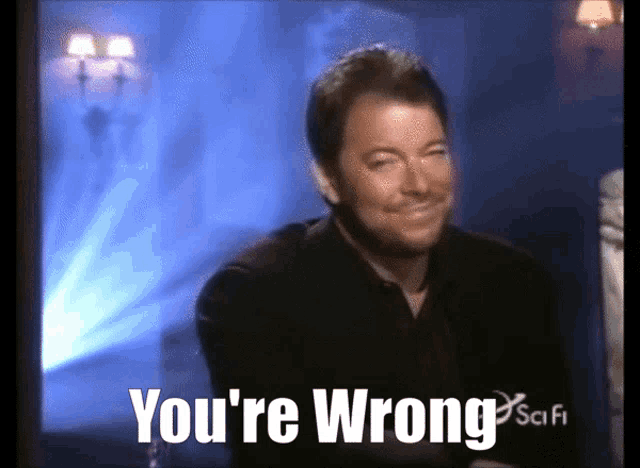a man is smiling with the words " you 're wrong " behind him