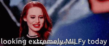 a woman with red hair is smiling with the words looking extremely milfy today behind her