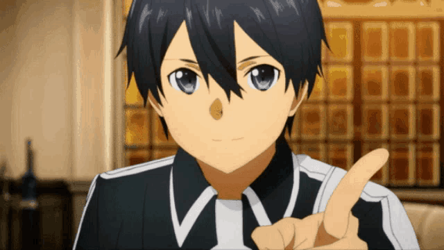 a boy with blue eyes is pointing his finger up