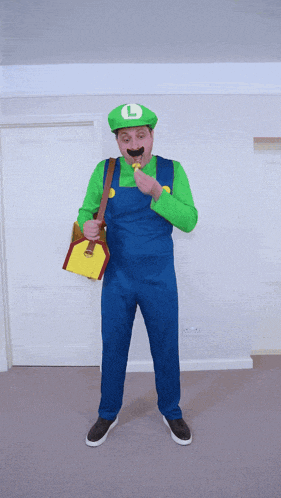 a man dressed as luigi from super mario is holding a shovel