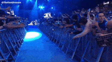 a crowd of people standing in front of a stage that says main underground on it