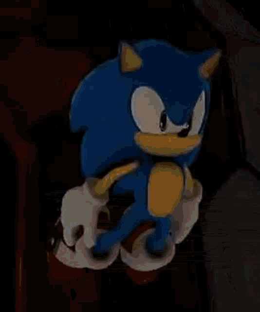 sonic the hedgehog is flying through the air while holding a remote control .