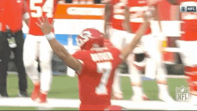 a football player wearing a red jersey with the number 7 on it