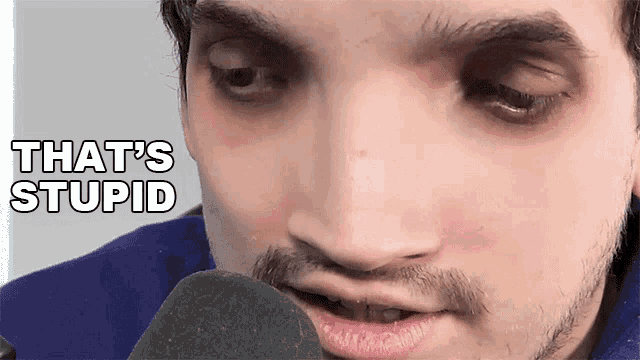 a close up of a man 's face with the words that 's stupid written above him