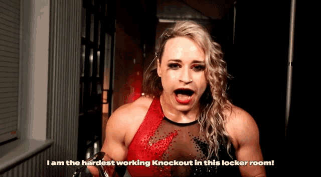 a woman in a red and black top says i am the hardest working knockout in this locker room