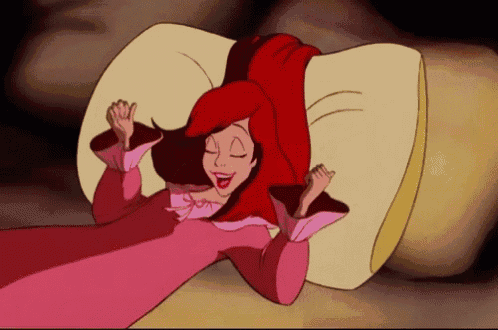 a cartoon character with red hair is laying on a pillow with her eyes closed
