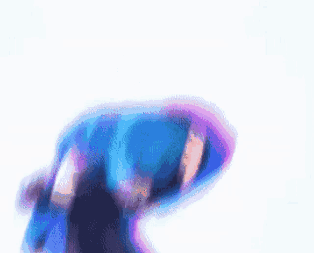 a blurred image of a person in a blue and purple outfit