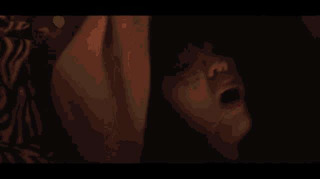 a close up of a woman 's face with blood coming out of her mouth .
