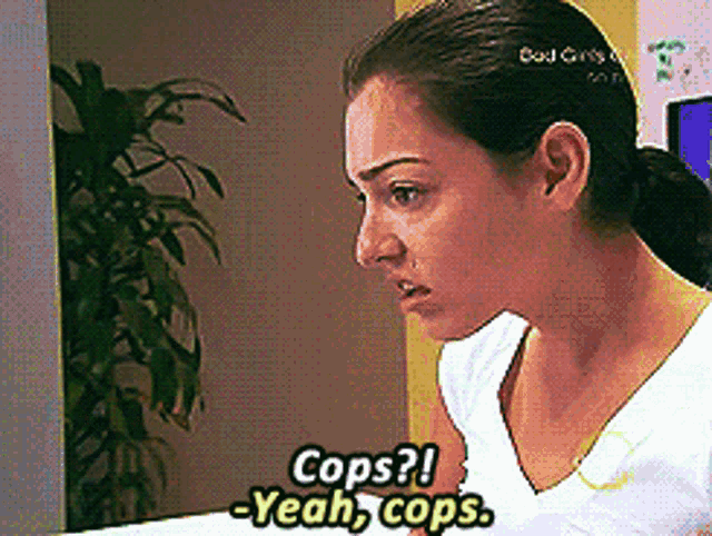 a woman says cops yeah cops while looking at a computer screen