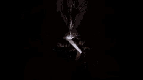 a dark room with a light coming out of a hole